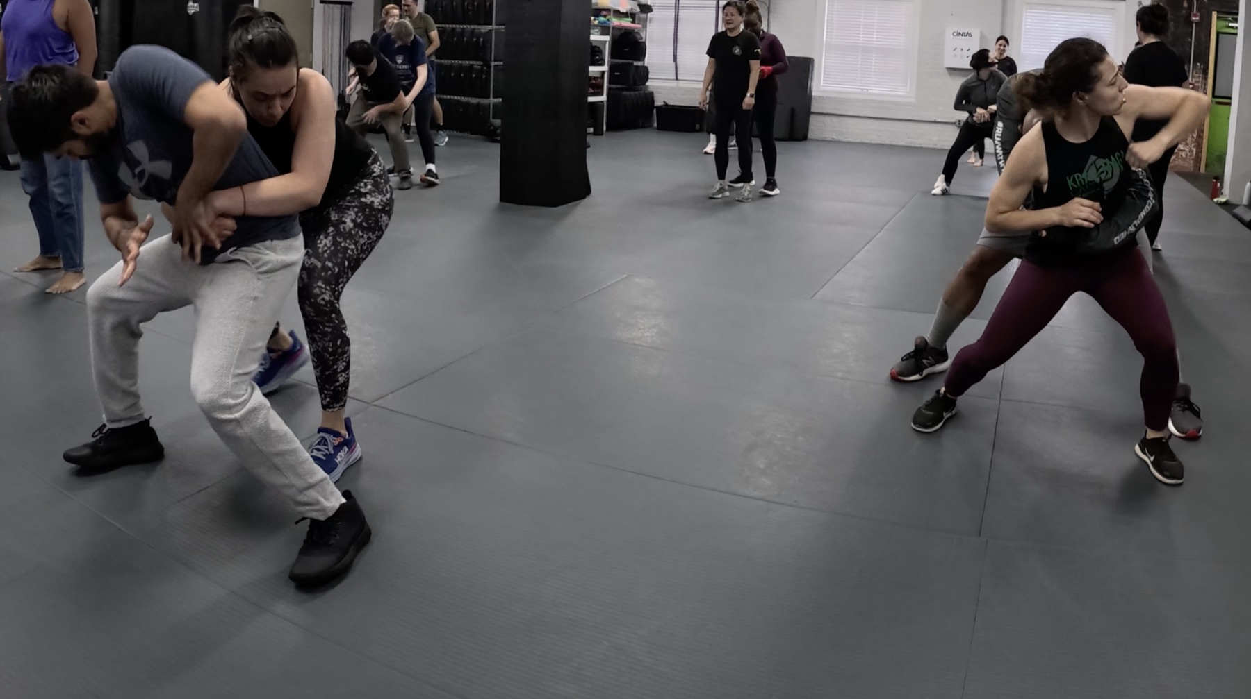 Participants practicing hands-on personal safety techniques during a Modern Threat Consulting class